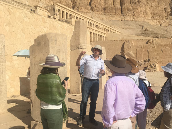 Bill Manley explains a hieroglyphic inscription in the temple-tomb of Mentuhotep Nebhepetra, one of the sites opened specially for our group