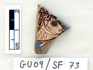 Gragment of tile decorated with a fish in cream and brown glaze - Medinet el-Gurob
